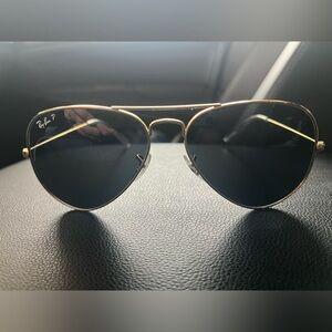 Ray Ban Classic aviator. Gold frame, black lenses.